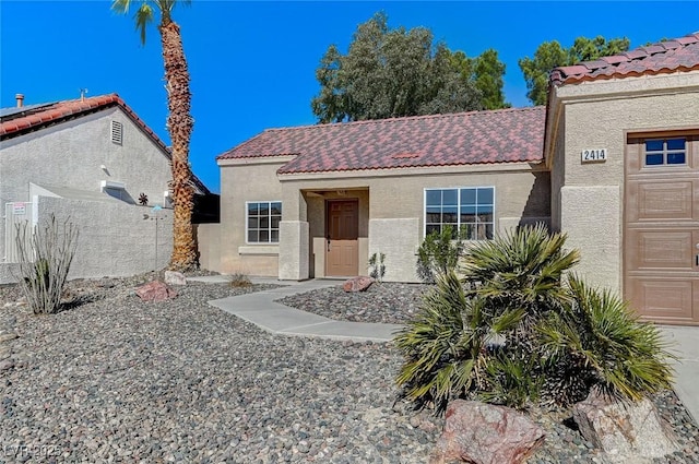 mediterranean / spanish-style home with a garage