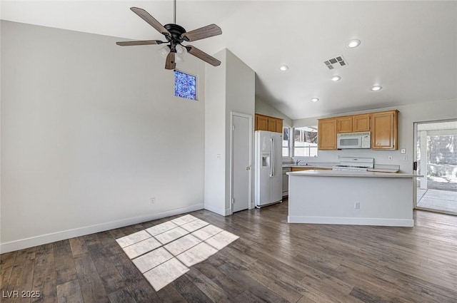 kitchen with ceiling fan, white appliances, dark hardwood / wood-style flooring, and a center island