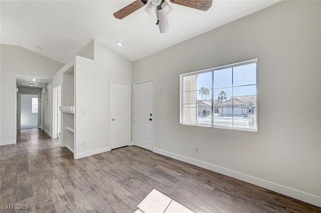 unfurnished room featuring lofted ceiling, ceiling fan, and light hardwood / wood-style flooring