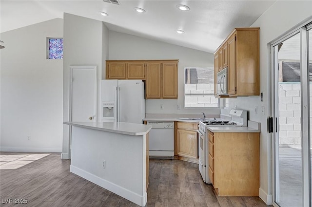 kitchen with vaulted ceiling, a center island, white appliances, and light wood-type flooring