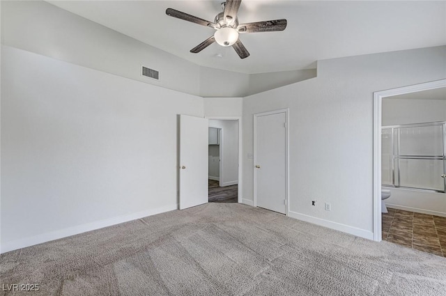 unfurnished bedroom featuring carpet, connected bathroom, lofted ceiling, and ceiling fan