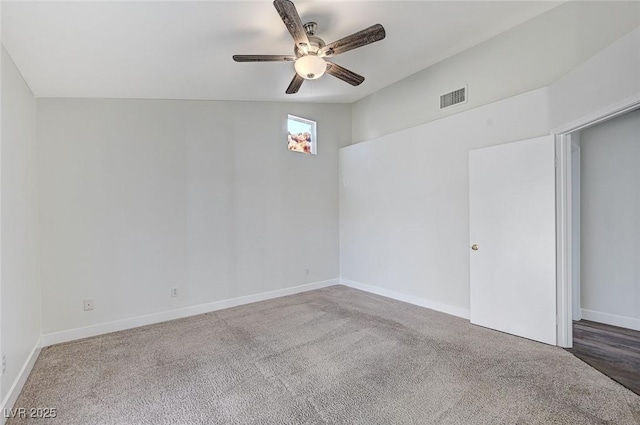 unfurnished room featuring ceiling fan and carpet