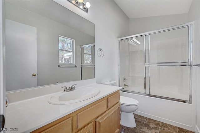 full bathroom featuring enclosed tub / shower combo, vanity, and toilet