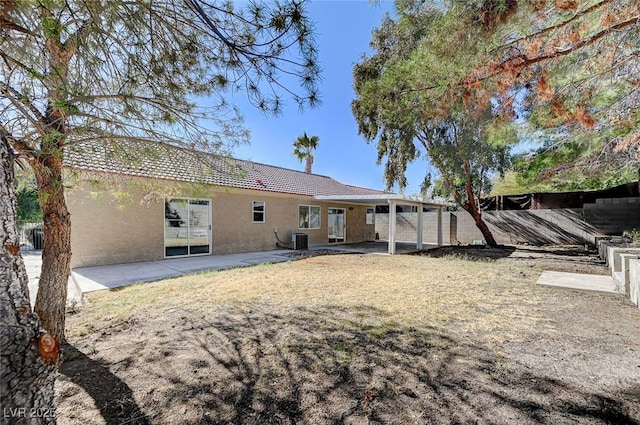 rear view of property featuring a patio and central air condition unit