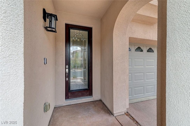 view of exterior entry featuring a garage