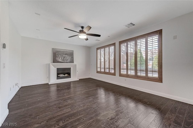 unfurnished living room featuring dark hardwood / wood-style flooring and ceiling fan