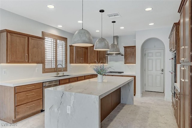 kitchen with sink, extractor fan, decorative light fixtures, stainless steel dishwasher, and a kitchen island