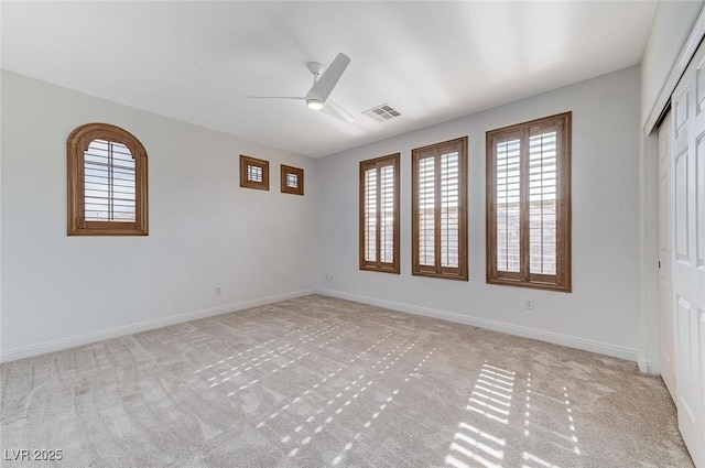 carpeted empty room featuring ceiling fan