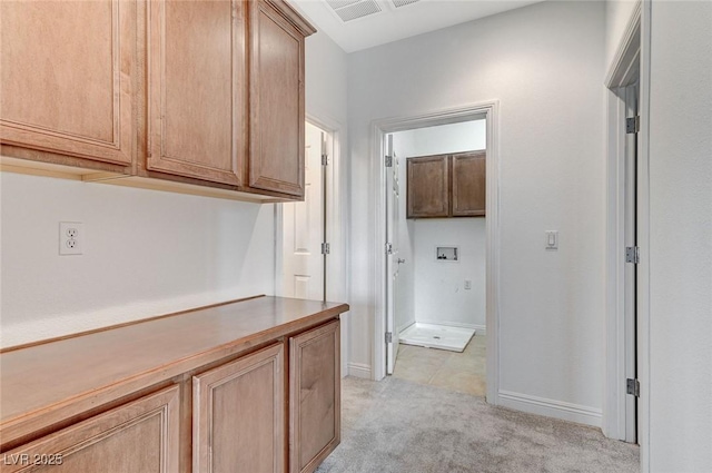 hall with light colored carpet and baseboards