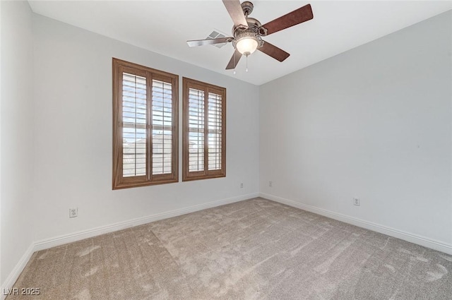 spare room featuring carpet floors, a ceiling fan, and baseboards