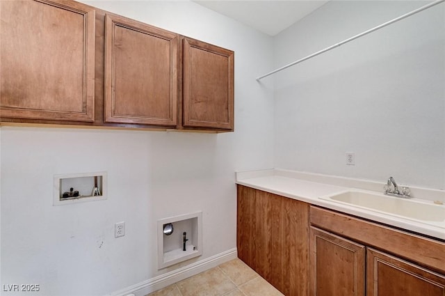 laundry area featuring washer hookup, cabinet space, a sink, and light tile patterned floors