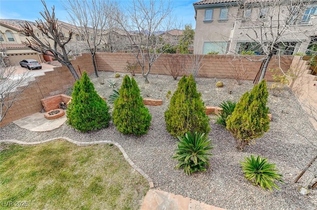 view of yard featuring an outdoor fire pit and a fenced backyard