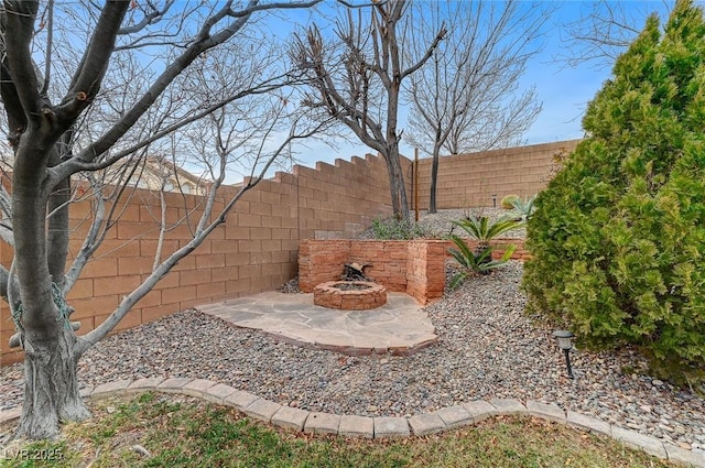 view of yard with a patio area and a fire pit