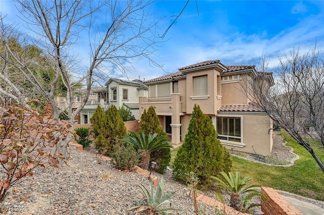 exterior space with a tile roof and stucco siding