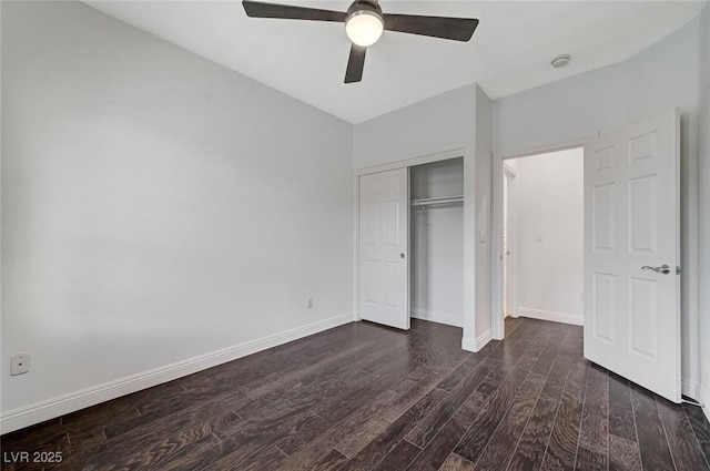 unfurnished bedroom with dark hardwood / wood-style flooring, a closet, and ceiling fan