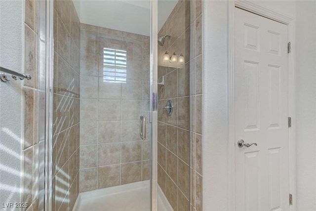 bathroom with a shower with door