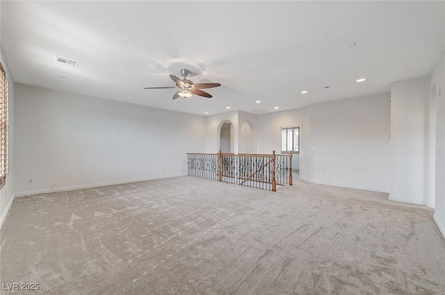 unfurnished living room with ceiling fan and light colored carpet