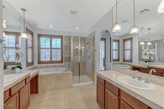 bathroom featuring tile patterned floors, plenty of natural light, separate shower and tub, and vanity