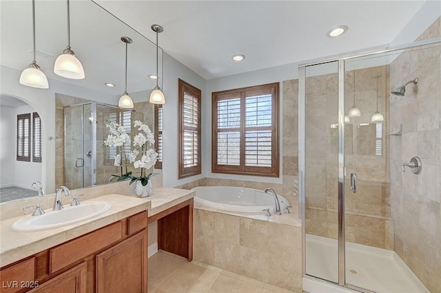 bathroom with a garden tub, a stall shower, tile patterned floors, and a healthy amount of sunlight