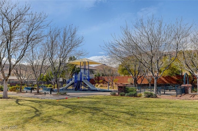 communal playground with a yard and fence