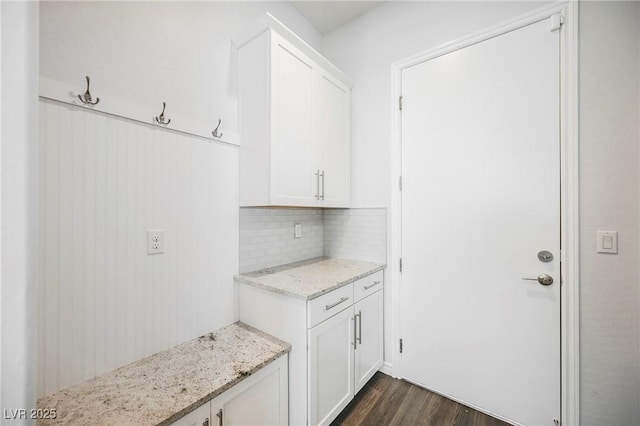 interior space with dark wood-style floors and backsplash