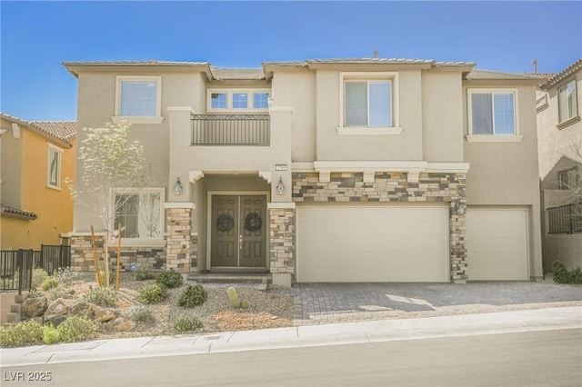 view of front of property with a garage, stone siding, and stucco siding