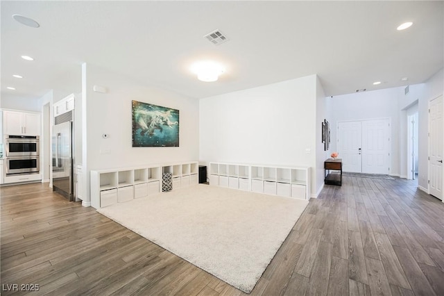 interior space with recessed lighting, visible vents, baseboards, and wood finished floors