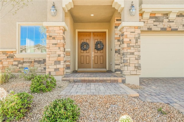 view of exterior entry featuring stone siding and stucco siding