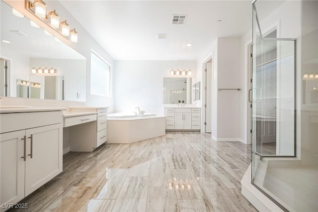 full bathroom featuring a stall shower, two vanities, a garden tub, and visible vents