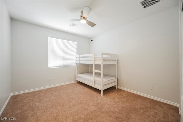 unfurnished bedroom featuring light carpet, baseboards, and visible vents