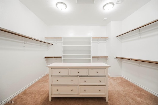 walk in closet featuring light carpet