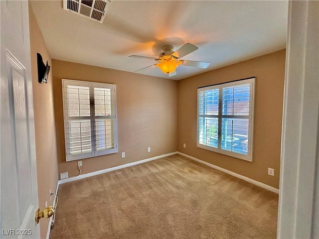 carpeted empty room with ceiling fan