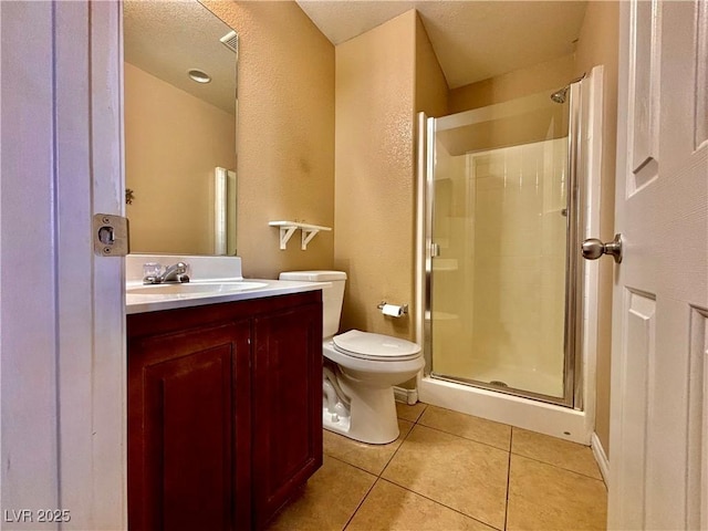 bathroom with vanity, tile patterned floors, toilet, and walk in shower