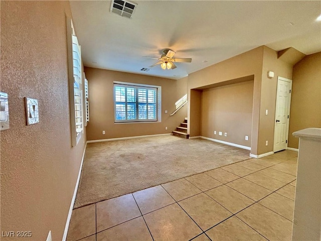 carpeted spare room featuring ceiling fan