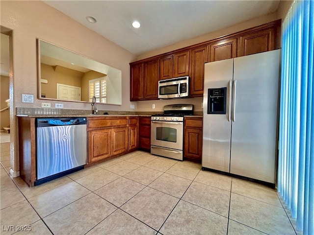 kitchen featuring appliances with stainless steel finishes, sink, and light tile patterned floors