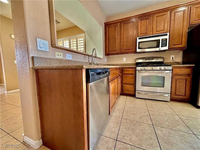 kitchen with stainless steel appliances and light tile patterned floors