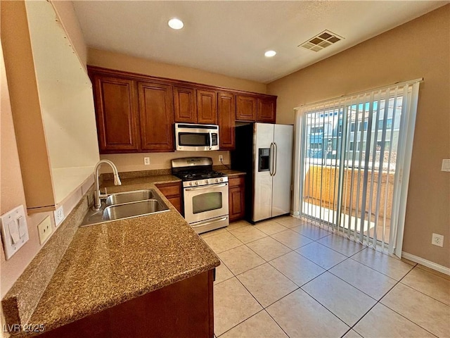 kitchen featuring light tile patterned flooring, stainless steel appliances, and sink