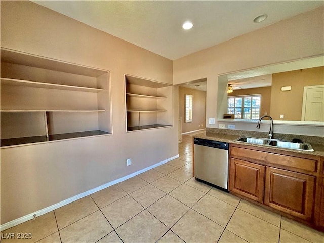 kitchen with sink, light tile patterned floors, built in features, and dishwasher