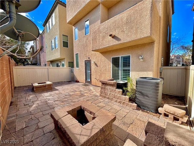 view of patio / terrace featuring a fire pit and central air condition unit