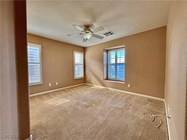 carpeted empty room with ceiling fan