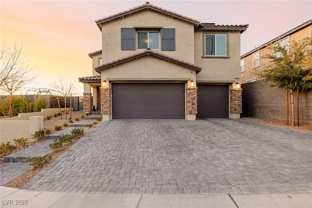 mediterranean / spanish home featuring a garage