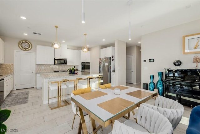 dining space with light tile patterned floors