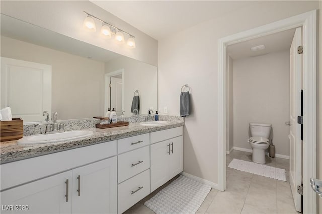 bathroom with vanity, tile patterned flooring, and toilet