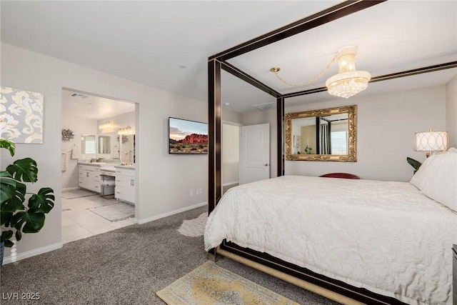 bedroom featuring light carpet, ensuite bath, and an inviting chandelier