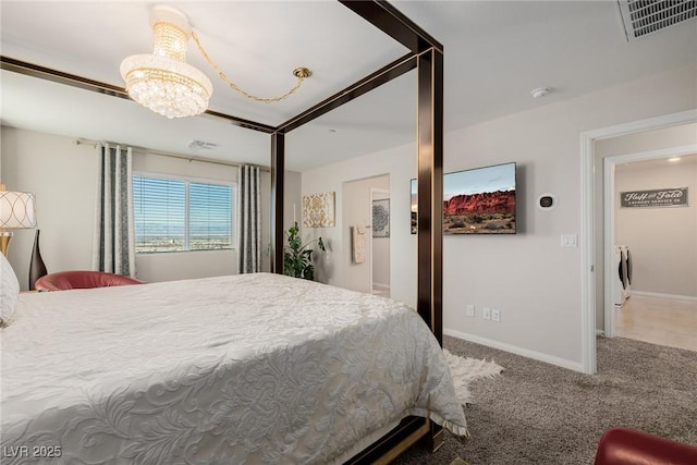 bedroom with carpet floors and an inviting chandelier