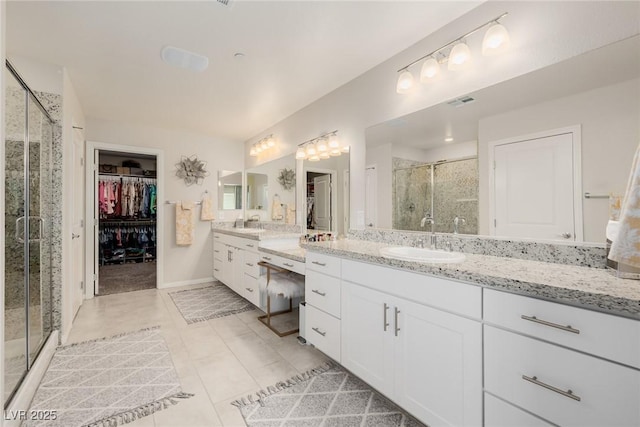 bathroom with vanity, an enclosed shower, and tile patterned flooring