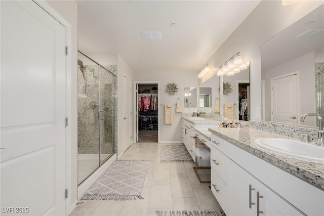 bathroom with tile patterned flooring, vanity, and an enclosed shower