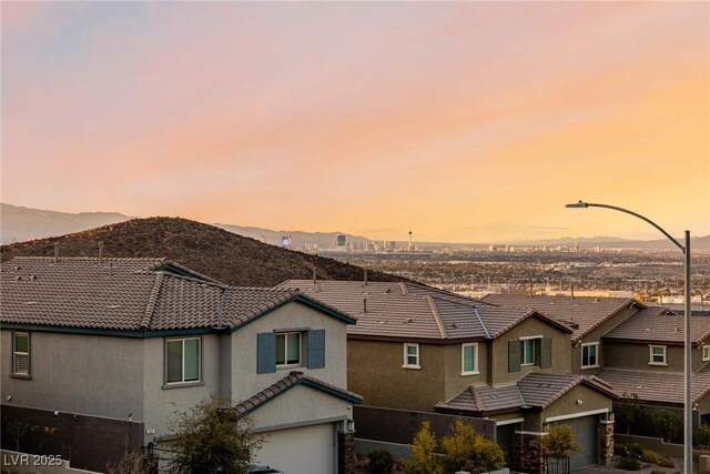 view of front of property with a garage and a mountain view