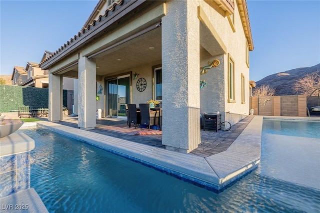 view of pool featuring a patio, a mountain view, and central AC