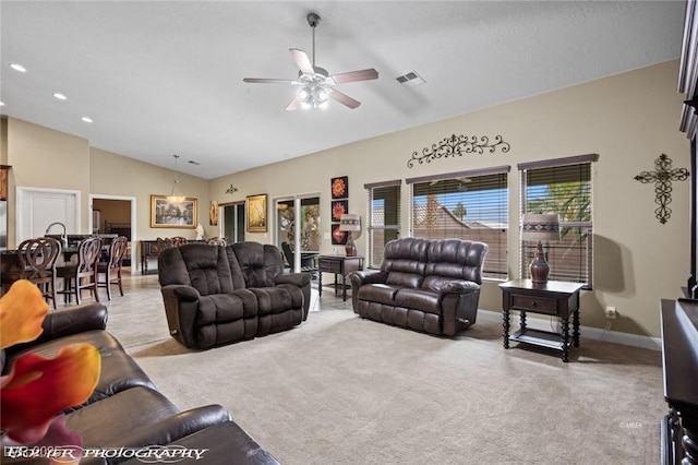 living room featuring ceiling fan, light colored carpet, and lofted ceiling